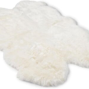 A plush, natural white sheepskin rug with an irregular shape, displayed on a clean white background.