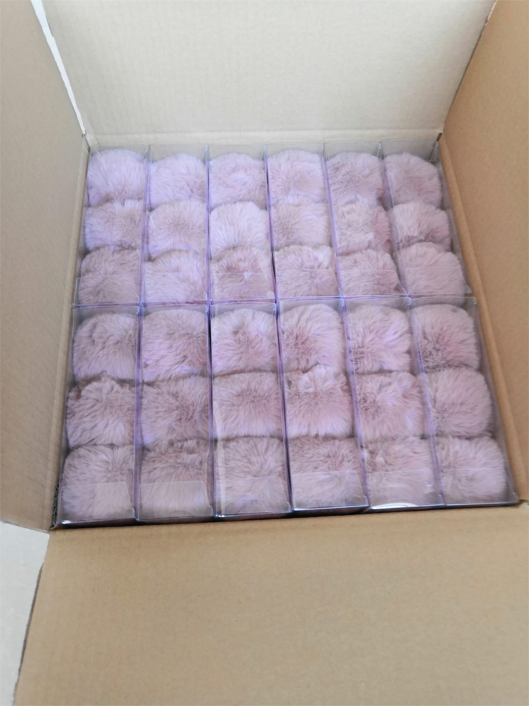 Boxed faux fur pom pom accessories ready for shipment