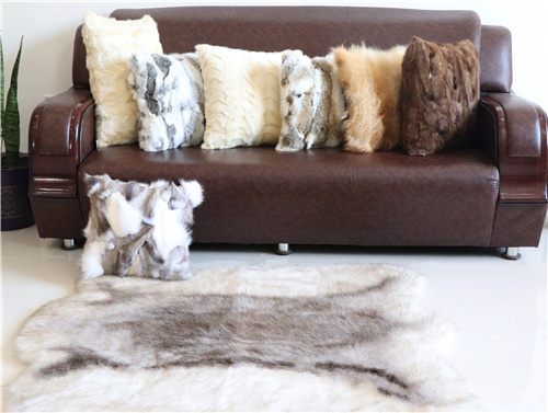 Real fur style cushion and rug arrangement for premium home decor buyers